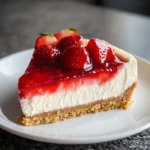 Delicious No Bake Strawberry Cheesecake topped with fresh strawberries.