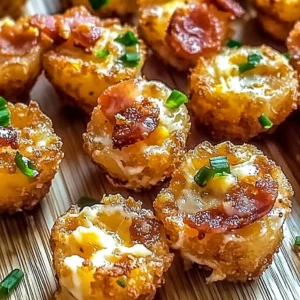 Loaded tater tots appetizers topped with cheese, bacon, and green onions