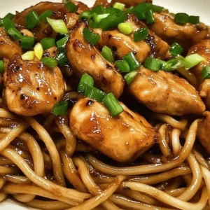 Plate of irresistible sticky garlic chicken noodles garnished with parsley