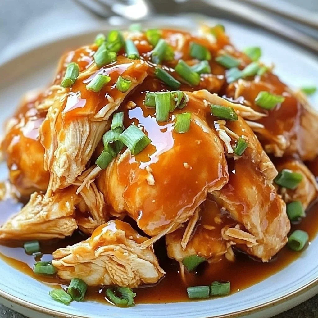 Delicious slow cooker honey sriracha chicken garnished with green onions
