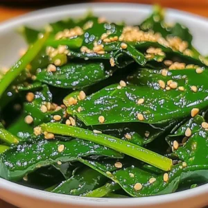 Korean Spinach Salad (Sigeumchi Namul) served in a bowl with sesame seeds.