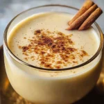 Glass of Vegan Almond Eggnog topped with nutmeg and cinnamon