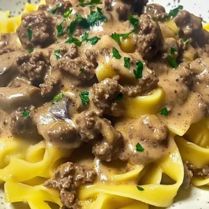 Dish of ground beef stroganoff served in a cozy, comforting style.