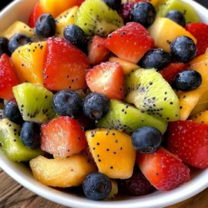 Colorful fresh fruit salad with honey lime poppy seed dressing