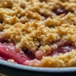 Gordon Ramsay's rhubarb crumble served with a scoop of ice cream on top.