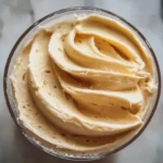 Delicious Honey Buttercream Frosting spread on a vanilla cupcake