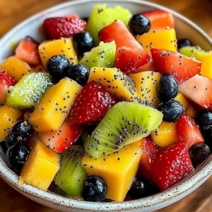 Colorful fresh fruit salad with honey lime poppy seed dressing