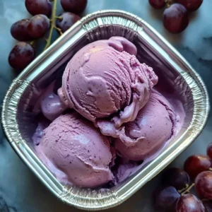 Delicious bowl of irresistible grape ice cream topped with fresh grapes