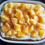 Delicious Pineapple Heaven Cake topped with fresh pineapple slices and cream