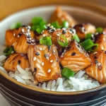 Crispy salmon rice bowl garnished with vegetables and sesame seeds