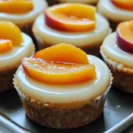 Delicious peach cheesecake cups topped with fresh peaches and whipped cream