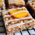 Irresistible peach oat bars with vanilla glaze on a wooden table