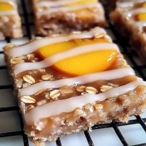 Irresistible peach oat bars with vanilla glaze on a wooden table