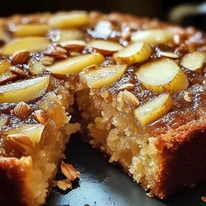 Slice of delicious Pear Brown Sugar Almond Cake topped with almonds and pear slices