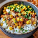 Irresistible street corn chicken rice bowl topped with fresh cilantro and spices.