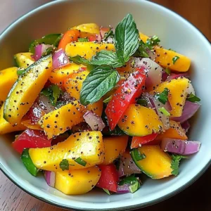 Colorful mango salad with lime dressing served in a bowl